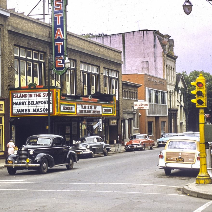 Old image of the commons facing towards the state theater with multiple old cars