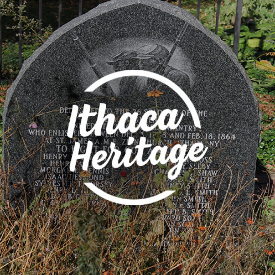 Circular text area that reads ”Ithaca Heritage” overlaid over an image of a veterans memorial.