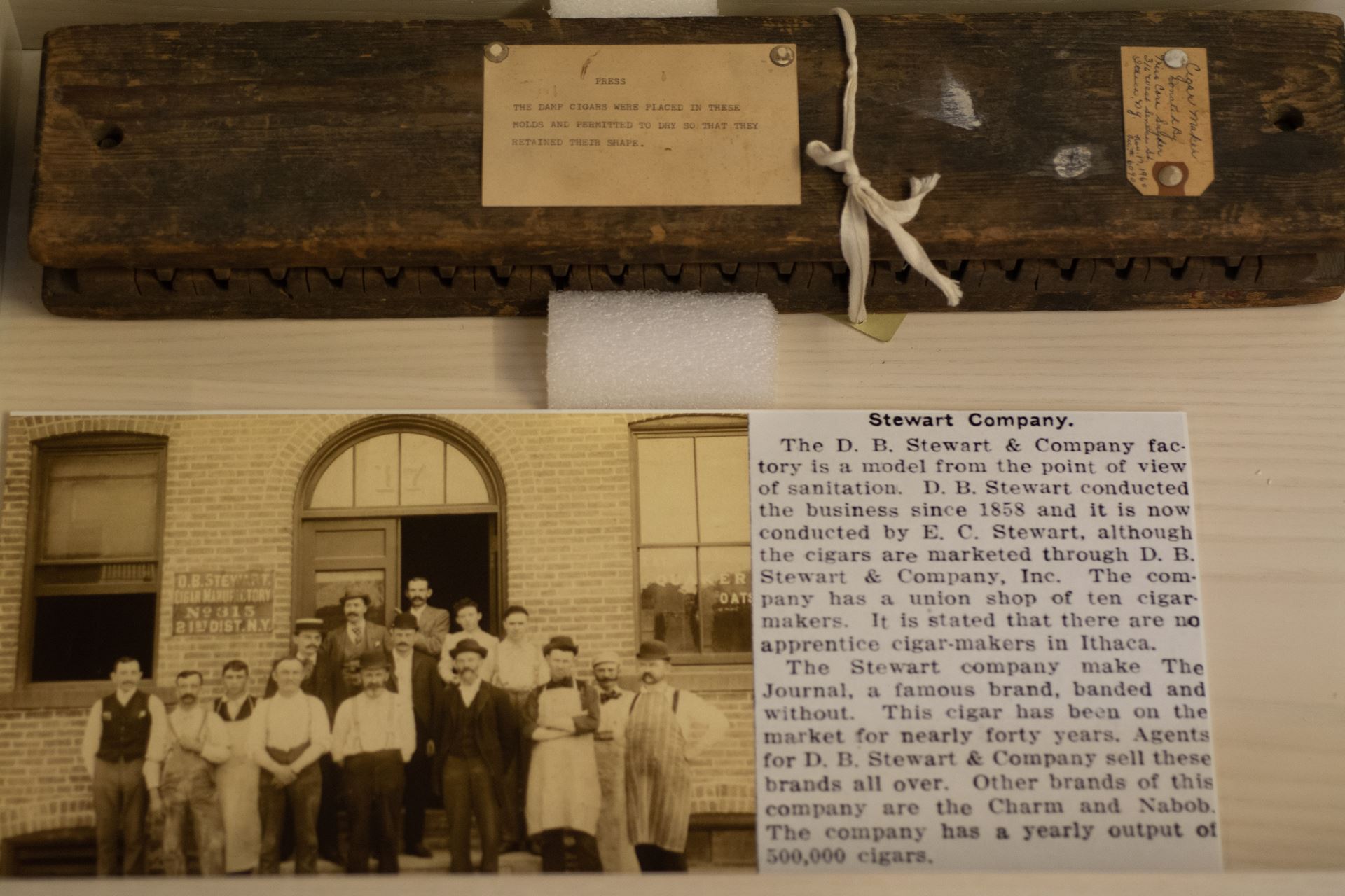 A small rectangular image of a historical photo labelled "Stewart Company" next to a description of the history of the Stewart Company.