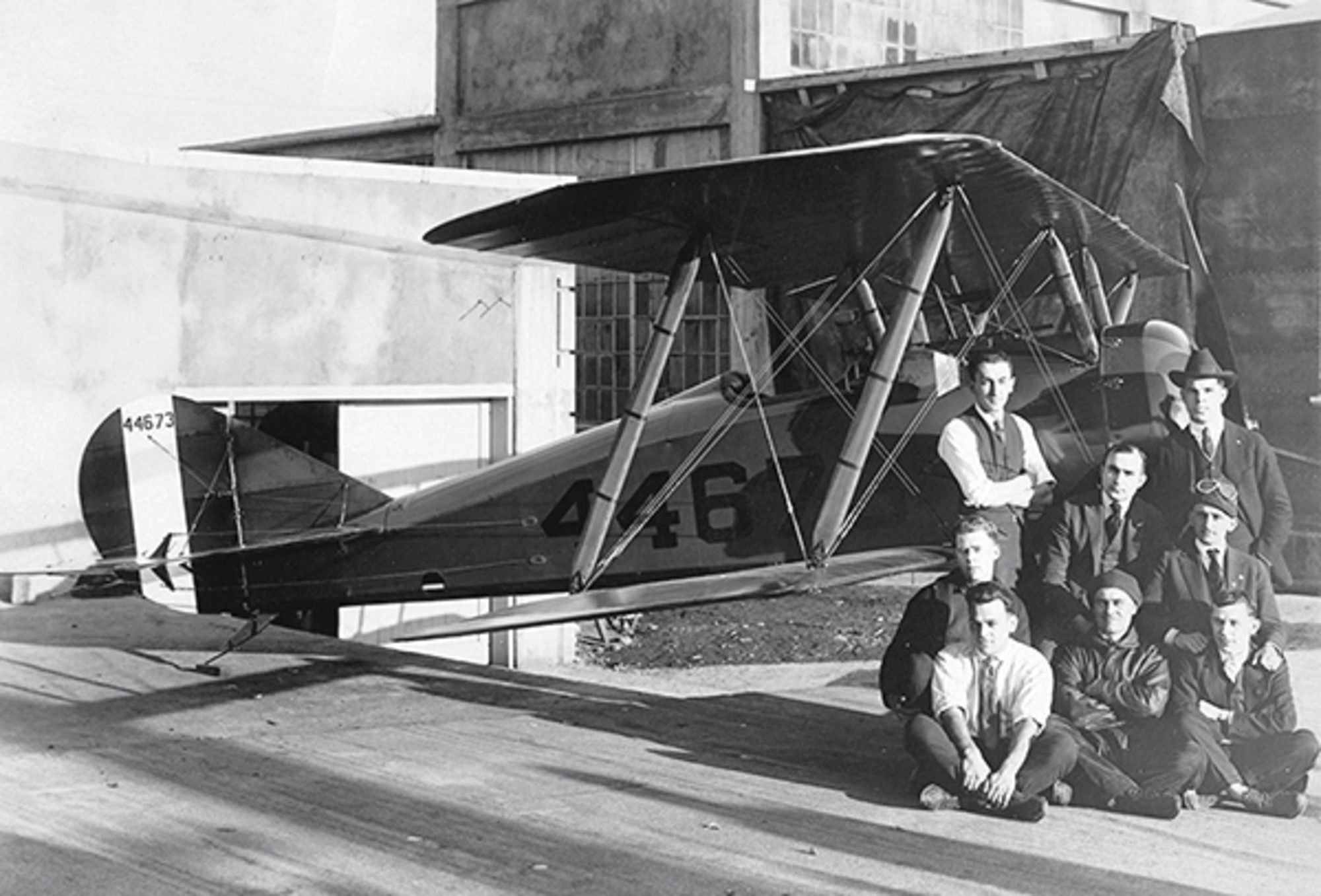 A black and white image of Thomas-Morse Factory Workers standing in front of a Tommy Plane, 1918.
