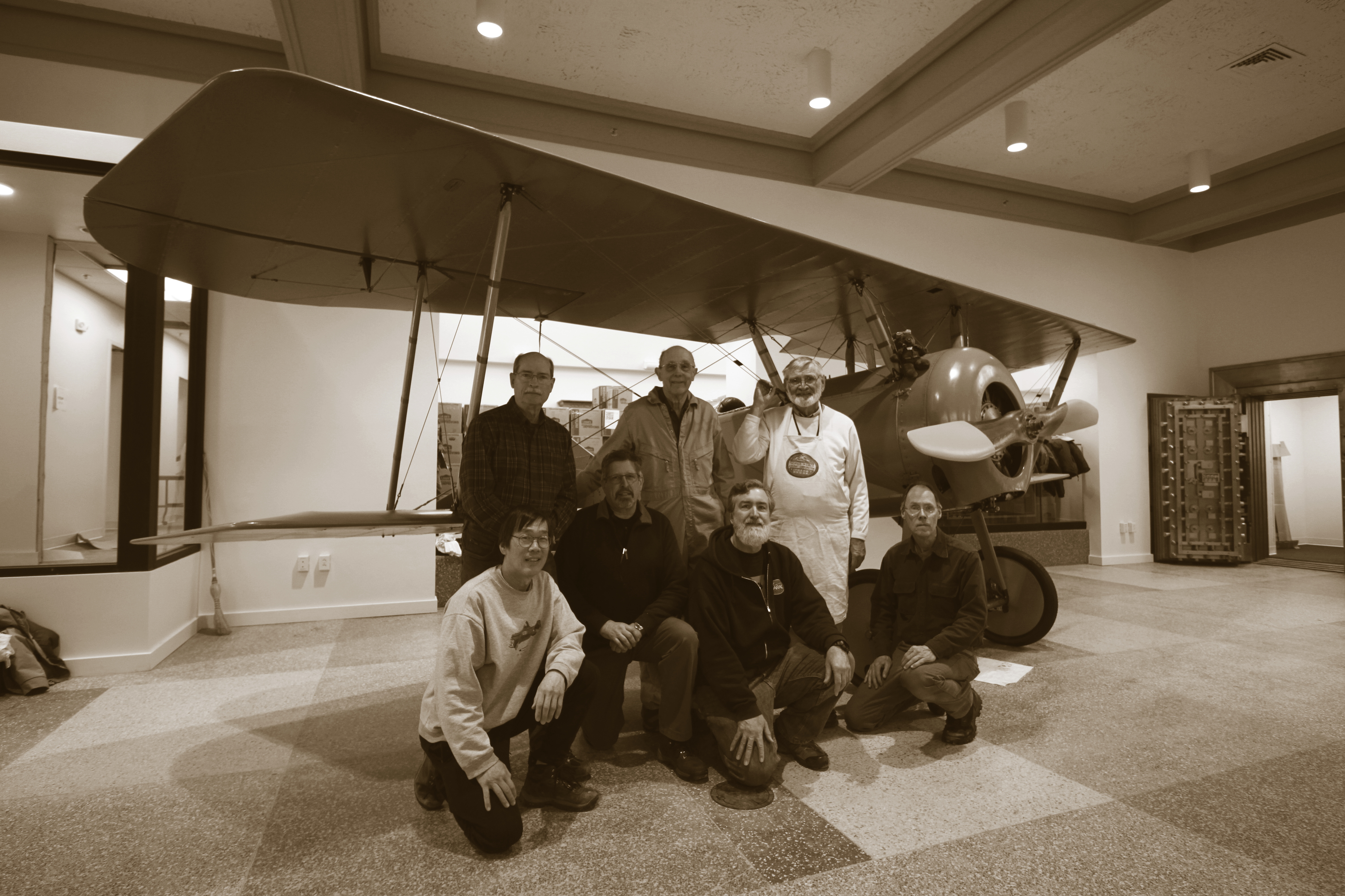 A photo of the IAHF restoration crew standing in front of the Tommy Plane, 2019